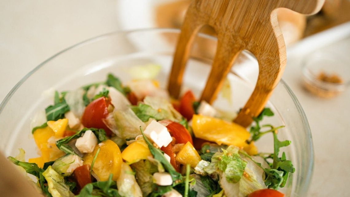 Vibrant vegetable salad with fresh ingredients in a glass bowl, perfect for healthy meals.