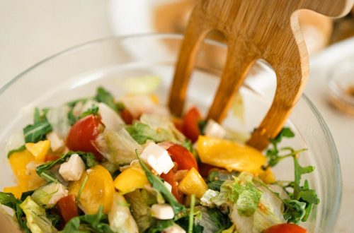 Vibrant vegetable salad with fresh ingredients in a glass bowl, perfect for healthy meals.