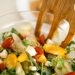 Vibrant vegetable salad with fresh ingredients in a glass bowl, perfect for healthy meals.